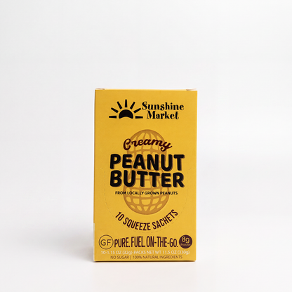 A yellow box of Sunshine Market Creamy Peanut Butter 10 squeeze sachets, 100% natural peanut butter
