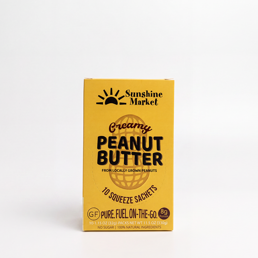 A yellow box of Sunshine Market Creamy Peanut Butter 10 squeeze sachets, 100% natural peanut butter