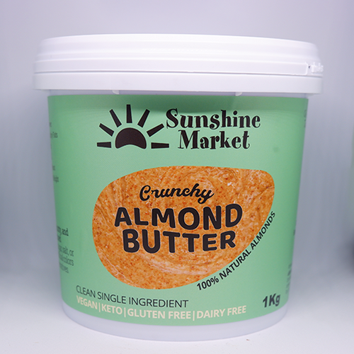 A container of Sunshine Market Almond Butter with the label facing forward. The label indicates that it is crunchy, vegan, gluten-free, and contains 100% natural almonds.