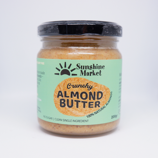 A jar of Sunshine Market Crunchy Almond Butter, 200g size, with a label that indicates it's gluten-free and made with 100% natural almonds.