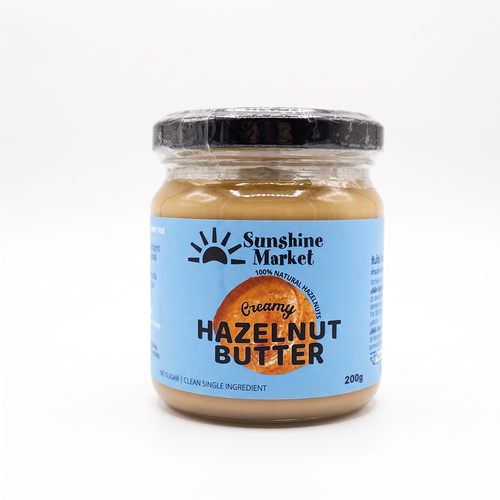 A jar of Sunshine Market Hazelnut Butter with a label showing the brand logo, the product name, and the weight of 200g.